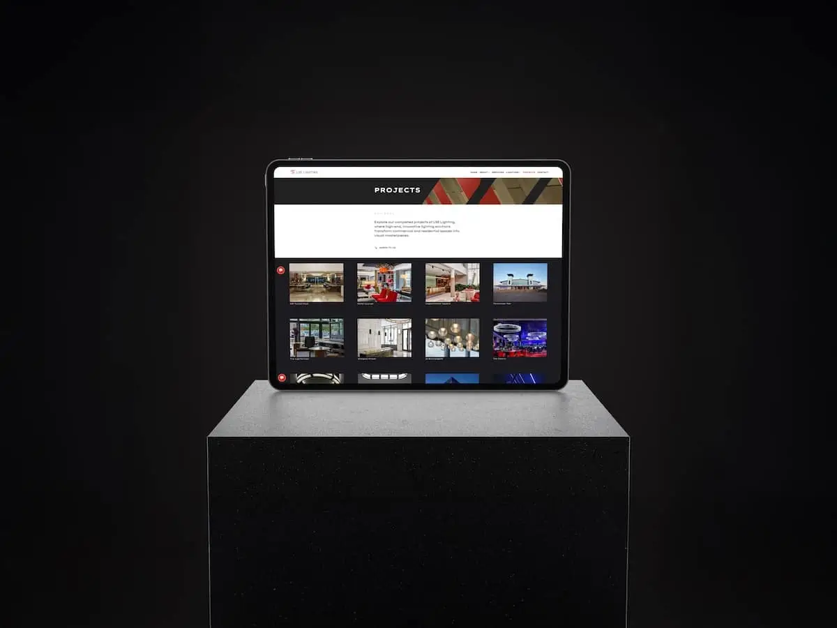 Tablet on a pedestal displaying a grid of project thumbnails under a 'PROJECTS' header on a dark screen background.