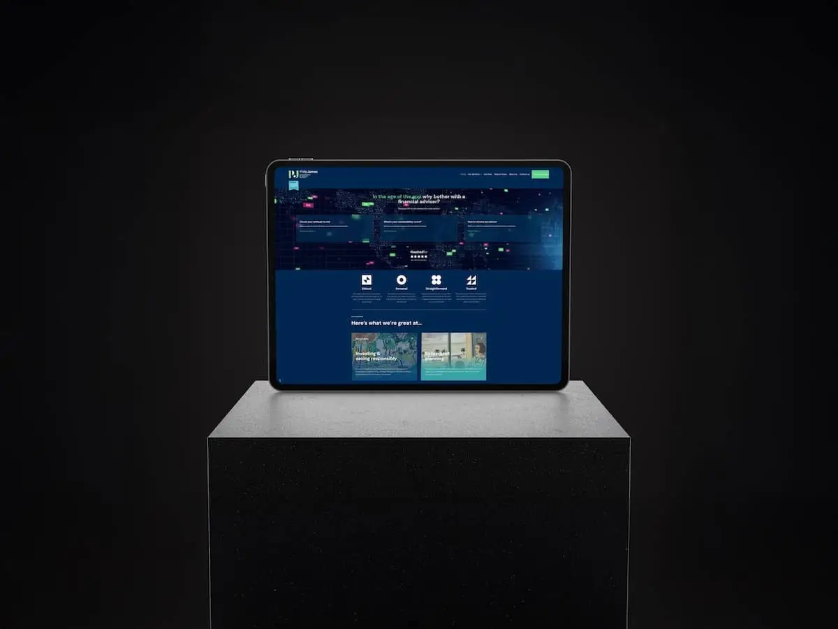 Tablet on a square pedestal in a dark studio, displaying a blue, grid-based website homepage on its screen.