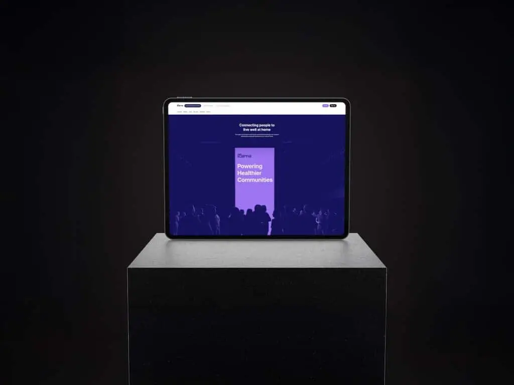 Tablet on a pedestal showing a purple conference slide reading 'Powering Healthier Communities' on a dark background.