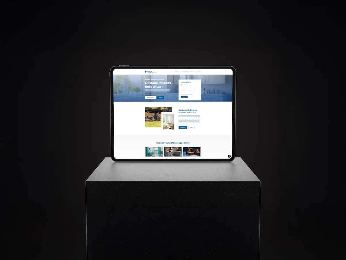 Tablet on a dark pedestal displaying a website mockup with a blue header and images on screen.